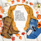 Autumn-themed outfit with sweater, boots, jeans, and text on a wooden surface with pumpkins and leaves.