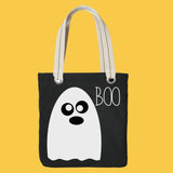 Black tote bag with a white ghost design and 'BOO' text on a yellow background