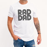 Person wearing a white t-shirt with 'RAD DAD' text on a plain background