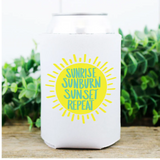 White container with a yellow sun graphic and text 'Sunrise Sunburn Sunset Repeat' on a wooden surface with greenery in the background.