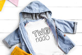 Children's denim jacket over a white t-shirt with 'TWO nado' text on a light wooden surface.